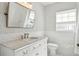 Elegant bathroom featuring marble countertops, tile flooring, and floral wallpaper at 3619 W Leona St, Tampa, FL 33629