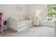 Cozy bedroom featuring a stylish daybed, soft carpet, and a bright window at 3619 W Leona St, Tampa, FL 33629