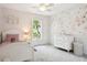 Charming bedroom with floral wallpaper, a large window and a comfortable bed at 3619 W Leona St, Tampa, FL 33629