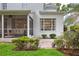 Charming backyard with brick patio, screened porch, and white painted brick exterior at 3619 W Leona St, Tampa, FL 33629