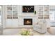 Cozy fireplace surrounded by built-in shelving and cabinets is the focus of this living space at 3619 W Leona St, Tampa, FL 33629