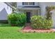 Inviting front porch with a brick pathway, lush greenery, and a stylish entryway at 3619 W Leona St, Tampa, FL 33629