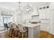Bright kitchen features an island with bar seating, pendant lights, and modern appliances at 3619 W Leona St, Tampa, FL 33629