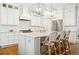 Stylish kitchen island offers seating and complements the stainless steel appliances and white cabinetry at 3619 W Leona St, Tampa, FL 33629