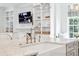 A well lit kitchen sink with marble counter top and white shelving at 3619 W Leona St, Tampa, FL 33629