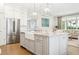 Modern kitchen with island seating flows seamlessly into the living area, perfect for entertaining at 3619 W Leona St, Tampa, FL 33629