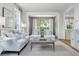 Elegant living room featuring stylish seating, large windows, and neutral color palette at 3619 W Leona St, Tampa, FL 33629