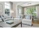 Comfortable living space with plush seating, bright lighting, and a view into the dining area at 3619 W Leona St, Tampa, FL 33629