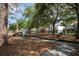 Community playground featuring play structures, swings, and open space for activities, fenced for safety at 3619 W Leona St, Tampa, FL 33629
