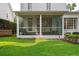 Covered screened in porch with wicker furniture and access to backyard with green space at 3619 W Leona St, Tampa, FL 33629