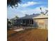 Backyard patio with outdoor dining and hammock offers ample room for relaxation and entertaining at 37535 Laurel Hammock Dr, Zephyrhills, FL 33541