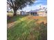 Large, expansive backyard with mature trees and shed offers ample space for outdoor activities and storage at 37535 Laurel Hammock Dr, Zephyrhills, FL 33541