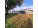 Backyard view featuring a shed, lush greenery, and a cozy patio setup at 37535 Laurel Hammock Dr, Zephyrhills, FL 33541