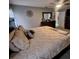The main bedroom offers a comfortable space with dark wood furniture, plush bedding and soft natural light at 37535 Laurel Hammock Dr, Zephyrhills, FL 33541