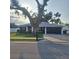 Charming one-story home with a well-maintained lawn, mature trees and a two car garage at 37535 Laurel Hammock Dr, Zephyrhills, FL 33541