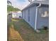 Home exterior showing the side yard, partial fence, and updated paint at 37535 Laurel Hammock Dr, Zephyrhills, FL 33541