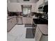 Bright kitchen featuring stainless steel appliances, tile floors, and a functional layout at 37535 Laurel Hammock Dr, Zephyrhills, FL 33541