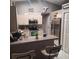 Contemporary kitchen featuring stainless steel appliances, tile floors, and a functional breakfast bar area at 37535 Laurel Hammock Dr, Zephyrhills, FL 33541