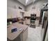 Well-equipped kitchen with stainless steel appliances and plenty of storage, perfect for cooking at 37535 Laurel Hammock Dr, Zephyrhills, FL 33541