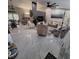 Bright, open-concept living room featuring tile floors and comfortable seating, great for entertaining at 37535 Laurel Hammock Dr, Zephyrhills, FL 33541