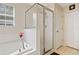 Bright bathroom featuring soaking tub, separate glass shower, and neutral tile flooring at 396 Winthrop Dr, Spring Hill, FL 34609
