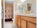 Bathroom featuring double sinks, a spacious vanity, and a beautifully decorated shower with a decorative shower curtain at 396 Winthrop Dr, Spring Hill, FL 34609