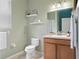 Bathroom with a soothing color palette, featuring a clean toilet, modern vanity, and ample natural light at 396 Winthrop Dr, Spring Hill, FL 34609