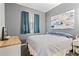Bedroom with a soft gray color scheme, featuring a comfortable bed, stylish curtains, and tasteful artwork at 396 Winthrop Dr, Spring Hill, FL 34609