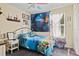 Bright bedroom with a cheerful undersea theme, complemented by a colorful ceiling fan and natural light from the window at 396 Winthrop Dr, Spring Hill, FL 34609