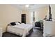 This bedroom has a ceiling fan and large window providing natural light, as well as neutral walls and flooring at 396 Winthrop Dr, Spring Hill, FL 34609