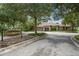 Inviting clubhouse entrance surrounded by lush landscaping and mature trees at 396 Winthrop Dr, Spring Hill, FL 34609