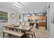 Inviting dining area featuring a large wooden table and chairs, open to the kitchen with a view to the backyard at 396 Winthrop Dr, Spring Hill, FL 34609