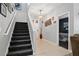 Inviting entryway with staircase, stylish chandelier, and easy access to a bedroom at 396 Winthrop Dr, Spring Hill, FL 34609