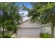 Charming two-story home featuring a two-car garage, well-maintained lawn and mature trees in a Gathering-friendly neighborhood at 396 Winthrop Dr, Spring Hill, FL 34609