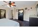 Comfortable bedroom features carpet flooring, modern ceiling fan, and a dark dresser at 396 Winthrop Dr, Spring Hill, FL 34609