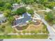 Overhead shot of house shows well-maintained lawn, nice landscaping, and great location near the water and other neighborhood homes at 401 Whitcomb Blvd, Tarpon Springs, FL 34689