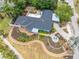 Overhead shot showcasing extensive landscaping, a large deck, and outdoor pergola for relaxing and entertaining at 401 Whitcomb Blvd, Tarpon Springs, FL 34689