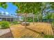 Backyard deck area with hot tub and surrounding foliage at 401 Whitcomb Blvd, Tarpon Springs, FL 34689