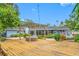 Expansive backyard deck featuring a hot tub under a pergola, perfect for outdoor relaxation and entertaining at 401 Whitcomb Blvd, Tarpon Springs, FL 34689