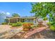 Well-manicured backyard with a screened-in porch and lush landscaping providing a serene outdoor space at 401 Whitcomb Blvd, Tarpon Springs, FL 34689