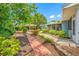 A walkway leads to a backyard with a pergola and screened-in porch, offering a peaceful retreat at 401 Whitcomb Blvd, Tarpon Springs, FL 34689
