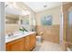 Bathroom with double vanity, tiled walls, and a window for natural light at 401 Whitcomb Blvd, Tarpon Springs, FL 34689