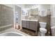 Bathroom featuring tile backsplash, double vanity with drawers and cabinets and decorative tile flooring at 401 Whitcomb Blvd, Tarpon Springs, FL 34689
