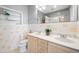 Well lit bathroom with double sinks, stylish tile and a built-in shelf at 401 Whitcomb Blvd, Tarpon Springs, FL 34689