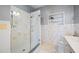 Bathroom featuring glass enclosed walk-in shower, built-in shelf and stylish tile at 401 Whitcomb Blvd, Tarpon Springs, FL 34689