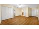 Bedroom boasts hardwood floors, a ceiling fan, and double closets for ample storage at 401 Whitcomb Blvd, Tarpon Springs, FL 34689
