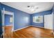 Cozy bedroom with blue walls, hardwood floors, a ceiling fan and bright light from the window at 401 Whitcomb Blvd, Tarpon Springs, FL 34689