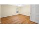 Sunlit bedroom featuring hardwood floors, a window, and a ceiling fan at 401 Whitcomb Blvd, Tarpon Springs, FL 34689