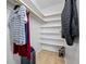 Walk-in closet with shelves, clothes, and suitcase, offering ample storage space at 401 Whitcomb Blvd, Tarpon Springs, FL 34689