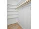 Walk-in closet with built-in shelving, tile floors and a hanging rod for clothes storage at 401 Whitcomb Blvd, Tarpon Springs, FL 34689